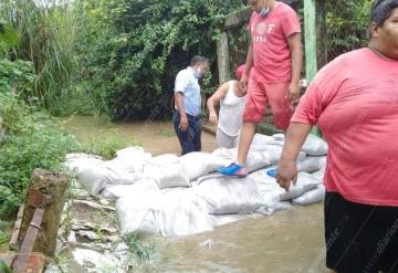 Vecinos de La Encarnación colocan costales y evitan más inundación